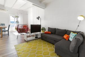 a living room with a couch and a table at Silver Coast - Casa da Lagoa in Foz do Arelho