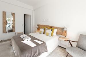 a bedroom with a large white bed with towels on it at Silver Coast - Casa da Lagoa in Foz do Arelho +45 photos