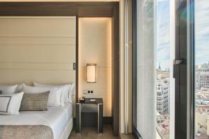 1 dormitorio con cama y vistas a la ciudad en VP Plaza España Design en Madrid