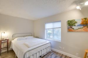 a white bedroom with a bed and a window at Tree-Lined Glenburn Vacation Rental with Fire Pit! in West Glenburn