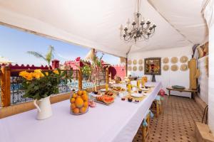 a white tent with a table with food on it at Riad Asrari in Marrakesh