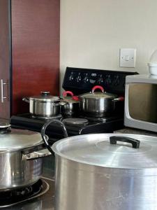 a kitchen with pots and pans on a stove at Cozy Farm 3BDRM 8 km ThabaBosiu in Maseru