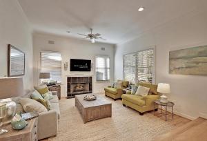 a living room with two couches and a fireplace at 7 Ocean Green in Kiawah Island