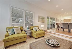 a living room with two chairs and a table at 7 Ocean Green in Kiawah Island