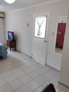 a white room with a door and a window at Cafaro in San Miguel de Tucumán