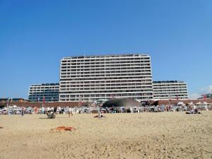 a group of people on a beach with a building at Metropol-276 in Westerland