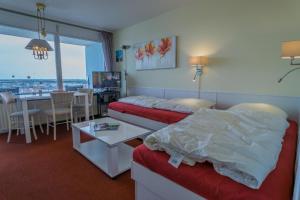 a hotel room with a bed and a table at Metropol-276 in Westerland