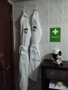 a bathroom with white towels hanging on a wall at ABRIGO DO CABECINHO - SERRA DA ESTRELA in Cortes do Meio