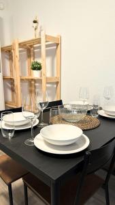 a black table with plates and wine glasses on it at Modern Studio - perfect location in Duisburg