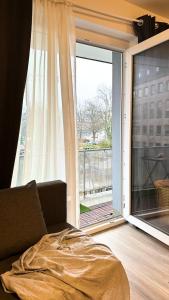 a bed in a room with a large window at Modern Studio - perfect location in Duisburg