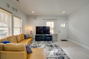a living room with a couch and a flat screen tv at Modern and Pet-Friendly Home 3 Mi to Dtwn Knoxville in Knoxville