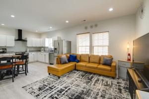 a living room with a couch and a kitchen at Modern and Pet-Friendly Home 3 Mi to Dtwn Knoxville in Knoxville