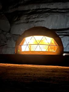 a lit up window in a stone building at Moon Magic Valley in Wadi Rum