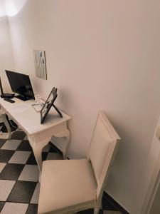 an office with a desk with a computer and a chair at Gutshaus Krimvitz Kleines Doppelzimmer inkl Frühstück in Putbus +3 photos