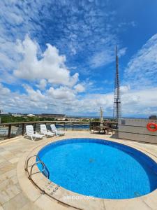 a swimming pool on the roof of a building at Brasil 21 Convention By Rei dos Flats in Brasilia