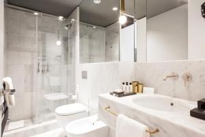 a bathroom with a toilet and a sink and a shower at Senato Hotel Milano in Milan