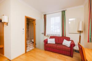 ein Wohnzimmer mit einem roten Stuhl und einem Fenster in der Unterkunft Ferien beim Steiner in Predlitz