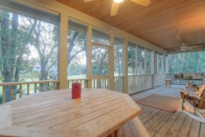 a large wooden porch with a wooden table on it at 4 Silver Moss in Kiawah Island