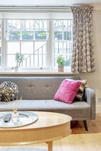 a living room with a couch and a coffee table at Elegant Marylebone Hideaway in London