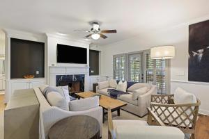 a living room with a couch and a fireplace at 5 Silver Moss in Kiawah Island