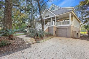 a large house with a porch and a garage at 5 Silver Moss in Kiawah Island