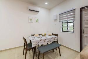 a dining room with a white table and chairs at DonDonDonny House 3Br Near Jonker@Heritage(9pax) in Melaka +13 photos