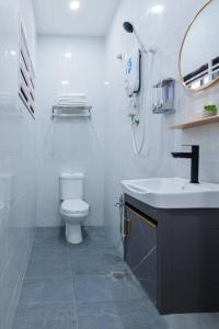 a white bathroom with a toilet and a sink at DonDonDonny House 3Br Near Jonker@Heritage(9pax) in Melaka
