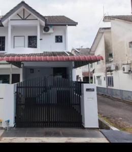a white house with a gate and a fence at DonDonDonny House 3Br Near Jonker@Heritage(9pax) in Melaka
