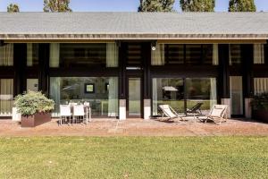 a house with chairs and a table in front of it at Agriturismo Corte d'acqua in Abano Terme