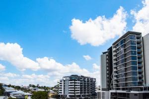 a view of two tall buildings in a city at Ideal Cozy 1BR for your Urban Escape in Gabba in Brisbane