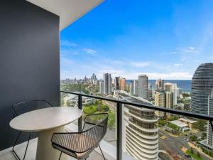 a balcony with a table and chairs and a view of the city at River and Ocean View Luxury 2BD Apt amazing Location in Gold Coast
