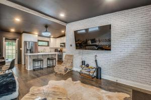 una cucina e un soggiorno con un muro di mattoni di Modern Atlanta Retreat Private Hot Tub and Yard! ad Atlanta
