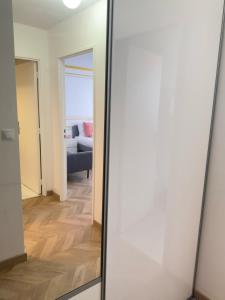 a mirror in a room with a living room at SCI IMMO PARIS PORTE DE CHOISY in Paris