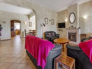 een woonkamer met 2 banken en een open haard bij Stylish Carvoeiro Villa - Short Walk to Resort Centre - Private Pool - Villa Serena - Algarve in Carvoeiro