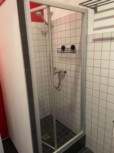 a shower in a bathroom with white tiles at 140 qm großes Loft mit 2 Schlafzimmern im Fabrikstil in Groß-Umstadt