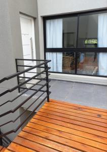 a balcony with a metal railing next to a window at El Trébol II in Necochea