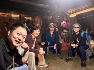 a group of people sitting in a room at Stone Paradise Homestay in Sa Pa