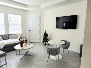 a living room with a couch and a christmas tree at Private Vacational Cozy Suite in Kissimmee