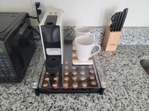 a tray with cups and a coffee maker on a counter at Private Vacational Cozy Suite in Kissimmee