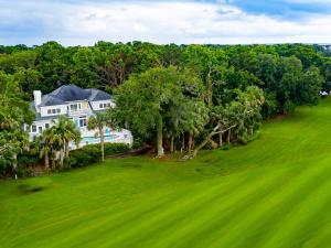 an aerial view of a large white house with trees at 317 Glen Eagle in Kiawah Island