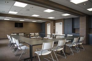 a conference room with a long table and chairs at Quality Inn Sept-Iles in Sept-Îles