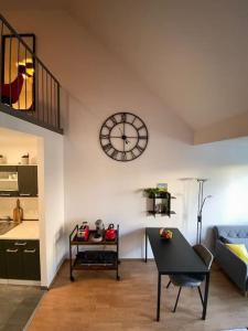 a living room with a clock on the wall at Loftcharakter auf 2 Etagen - Zentral in Essen! in Essen