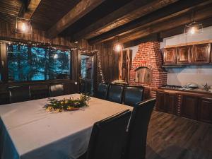 a dining room with a table and some chairs at Silvia Chalet Poiana Brasov in Braşov