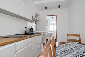 a kitchen with white cabinets and a counter top at APARTAMENT PRZY RYNKU II in Chełmno