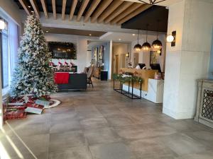 a christmas tree in a lobby with a store at Lake Placid Inn Boutique Hotel in Lake Placid