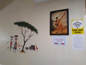 a wall with a picture and a tree on it at Madurai Grands Inn in Madurai