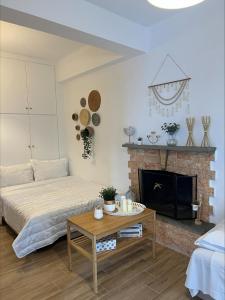 a living room with a bed and a fireplace at Platanidia Guesthouse in Platanidia