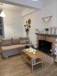 a living room with a couch and a fireplace at Platanidia Guesthouse in Platanidia