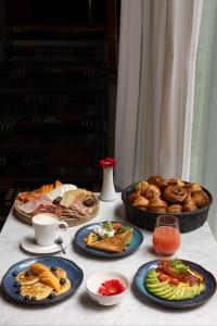 a table topped with plates of food and bread at Hotel Le Place d'Armes - Relais & Châteaux in Luxembourg