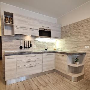 a kitchen with white cabinets and a counter top at Al Glicine Apartments in Lazise